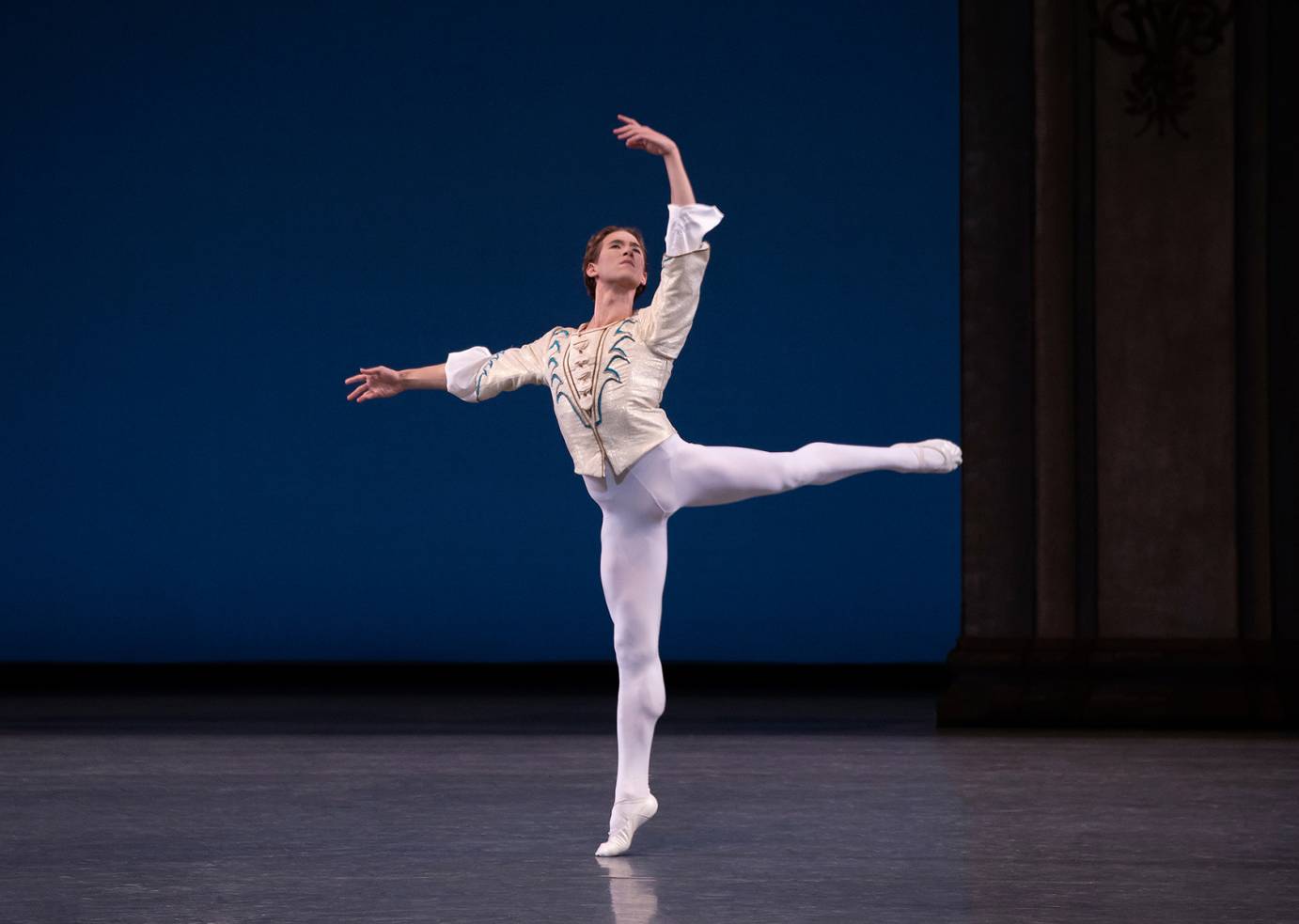 Joseph Gordon balances in an arabesque, one arm rounded overhead, the other extended to the side